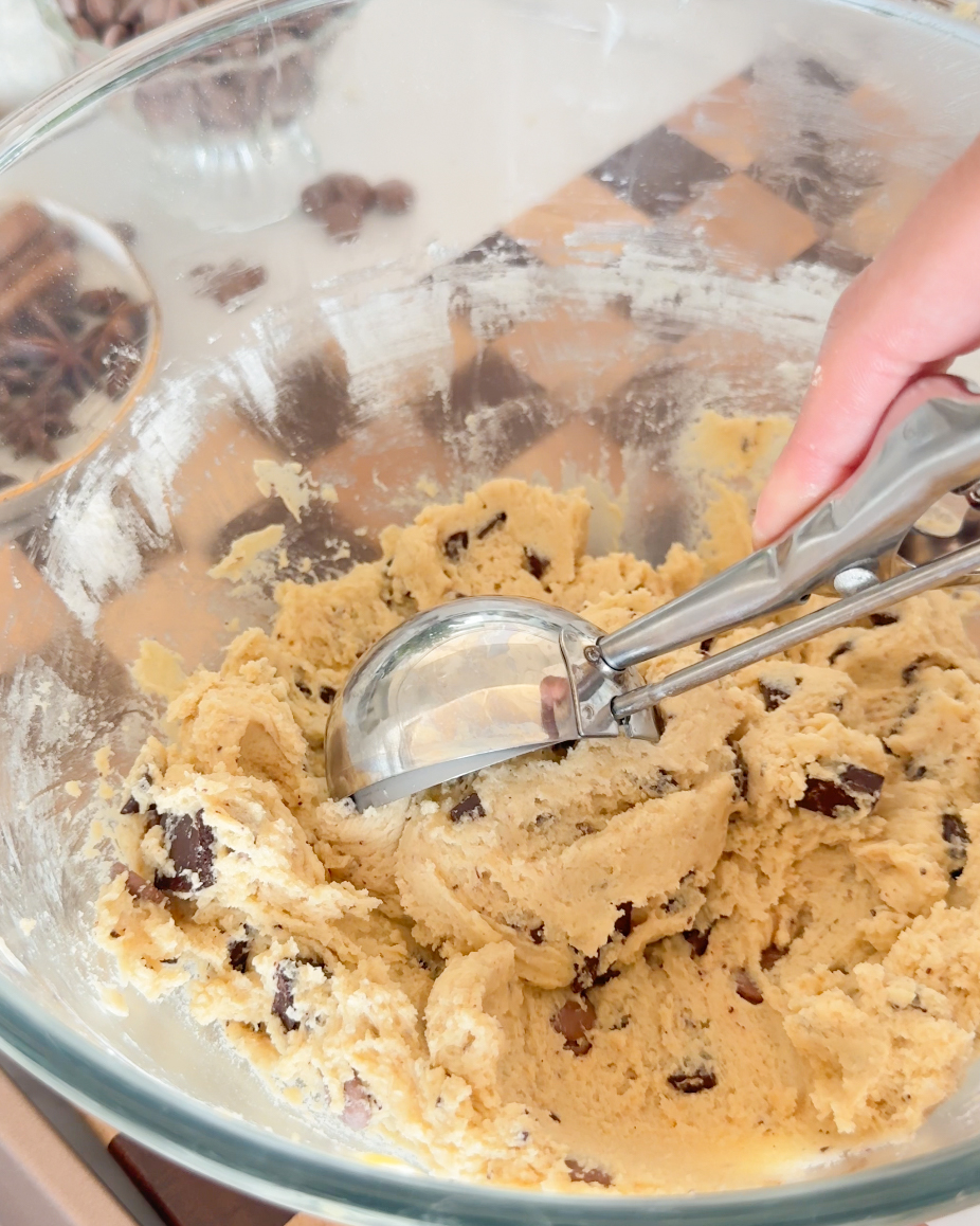 scooping cookie dough from a bowl