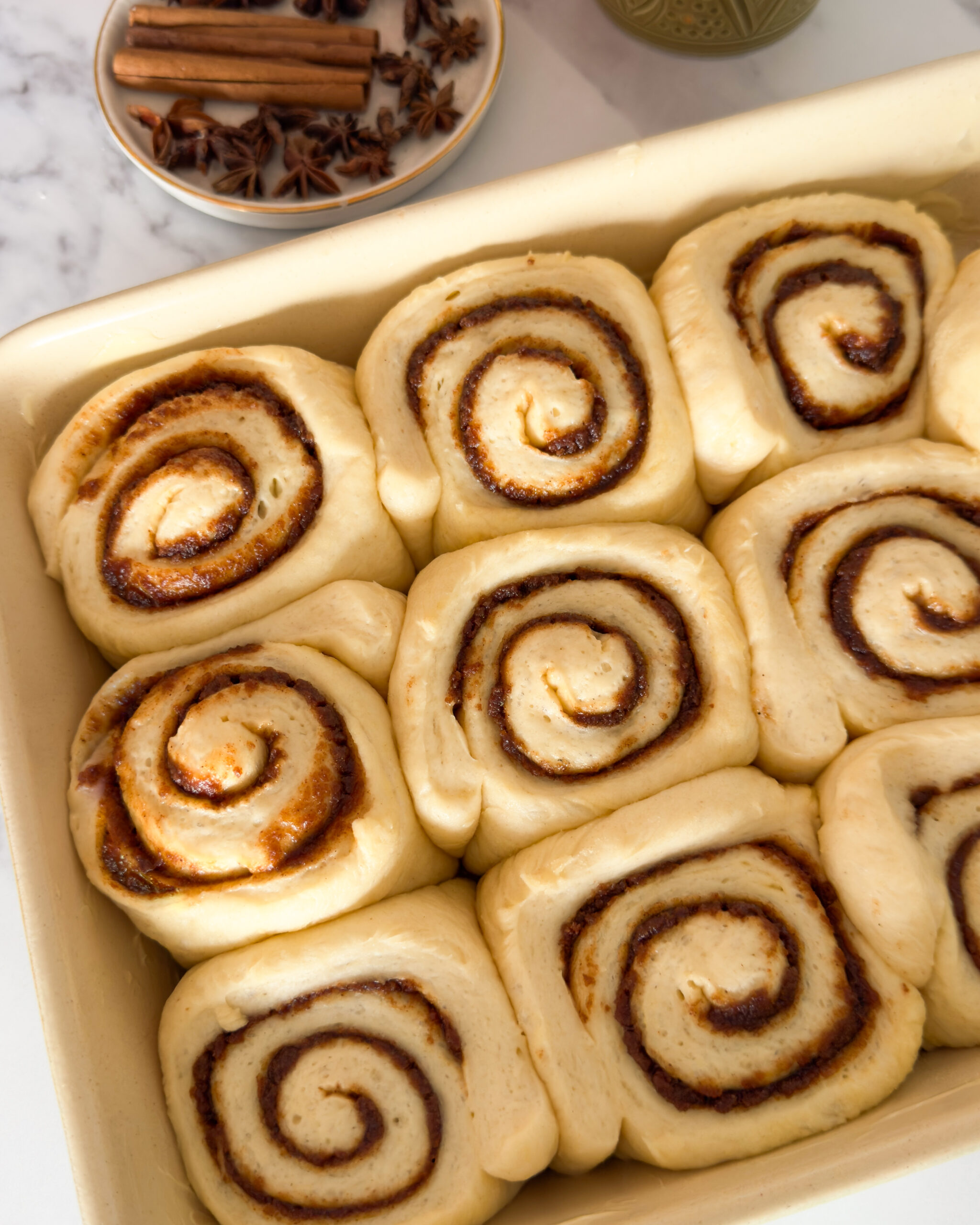 cinnamon rolls in baking dish, before baking
