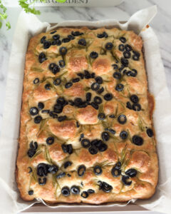 focaccia with rosemary and olives in baking tray