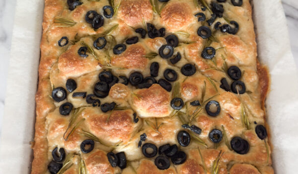 focaccia with rosemary and olives in baking tray