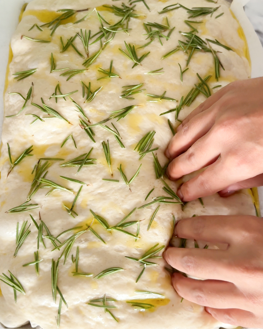adding dimples to focaccia dough